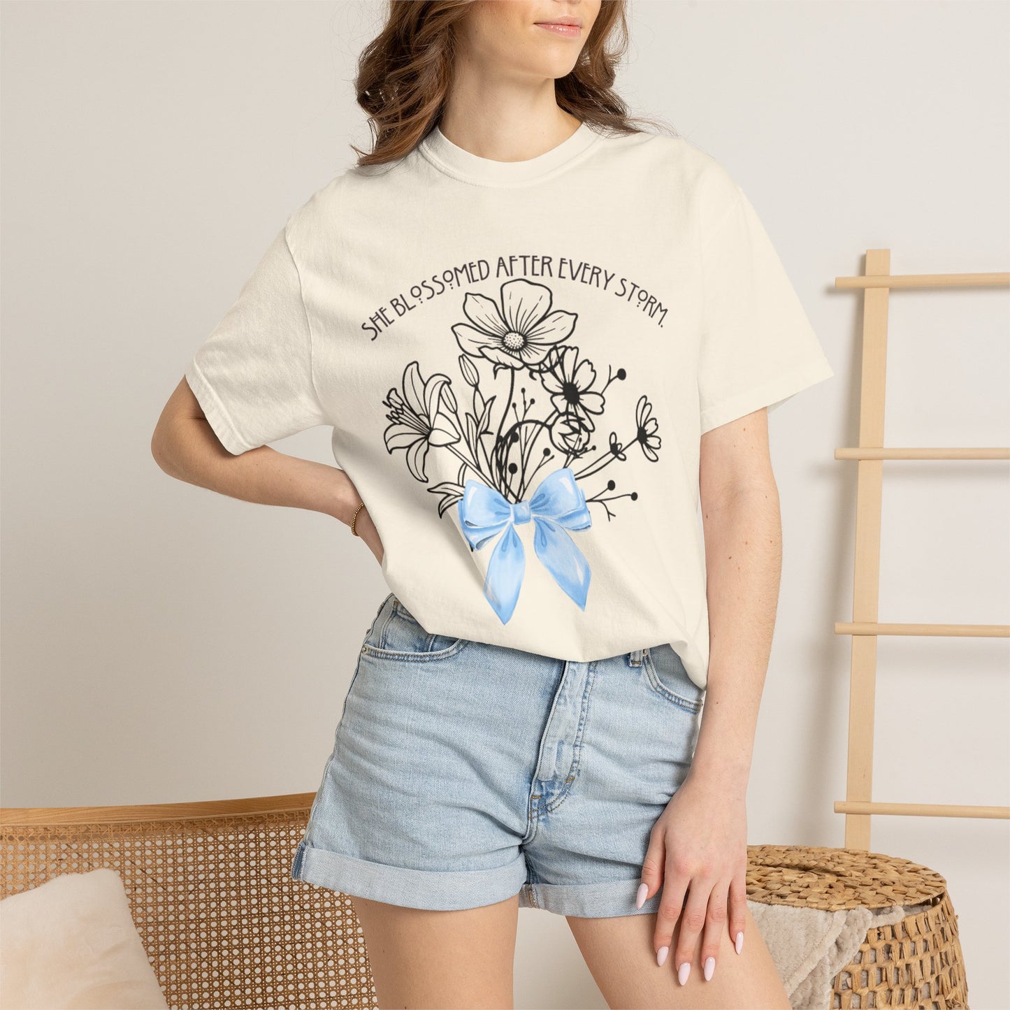 T-Shirt — 'She Blossomed After Every Storm' Floral Bouquet Tee with Blue Ribbon