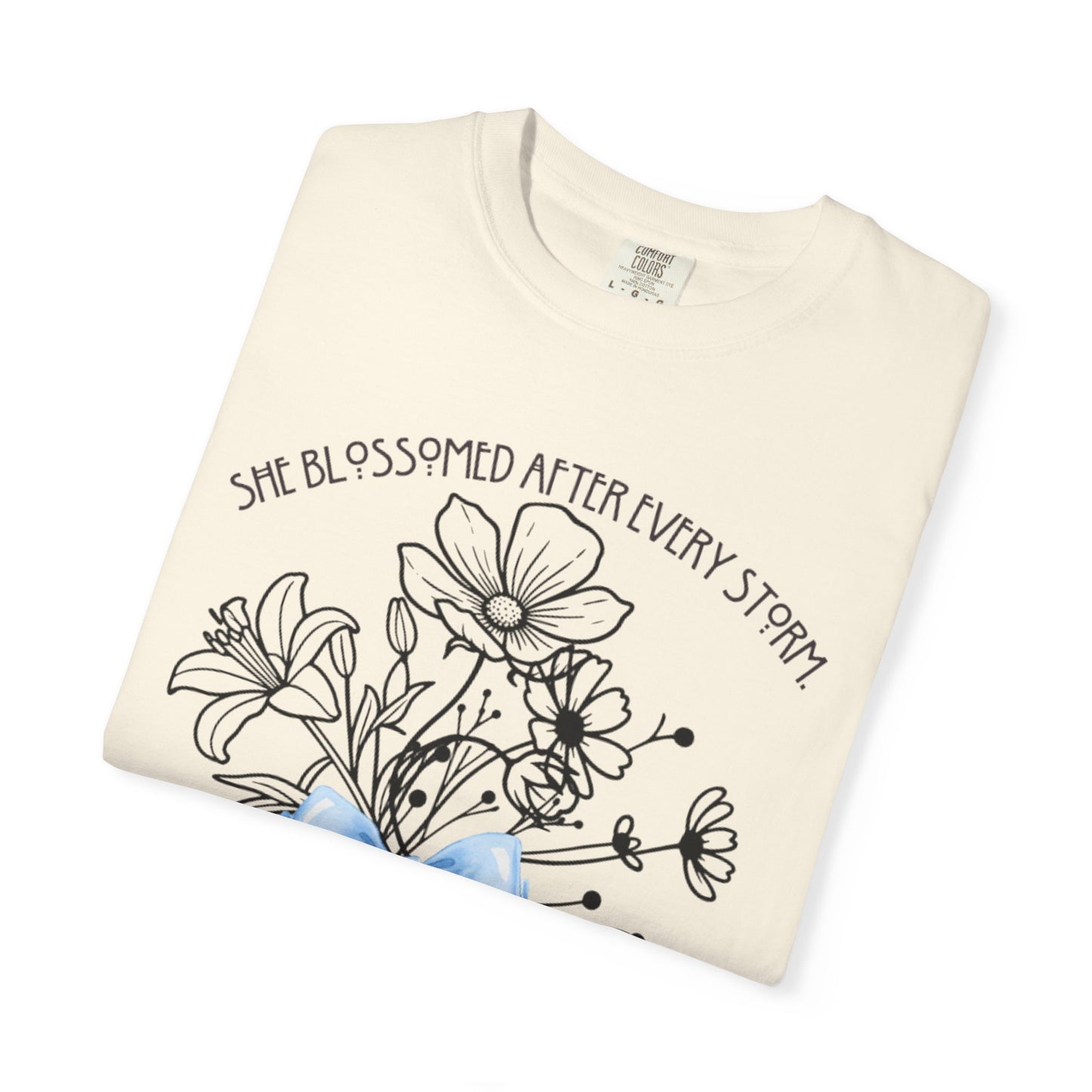 T-Shirt — 'She Blossomed After Every Storm' Floral Bouquet Tee with Blue Ribbon
