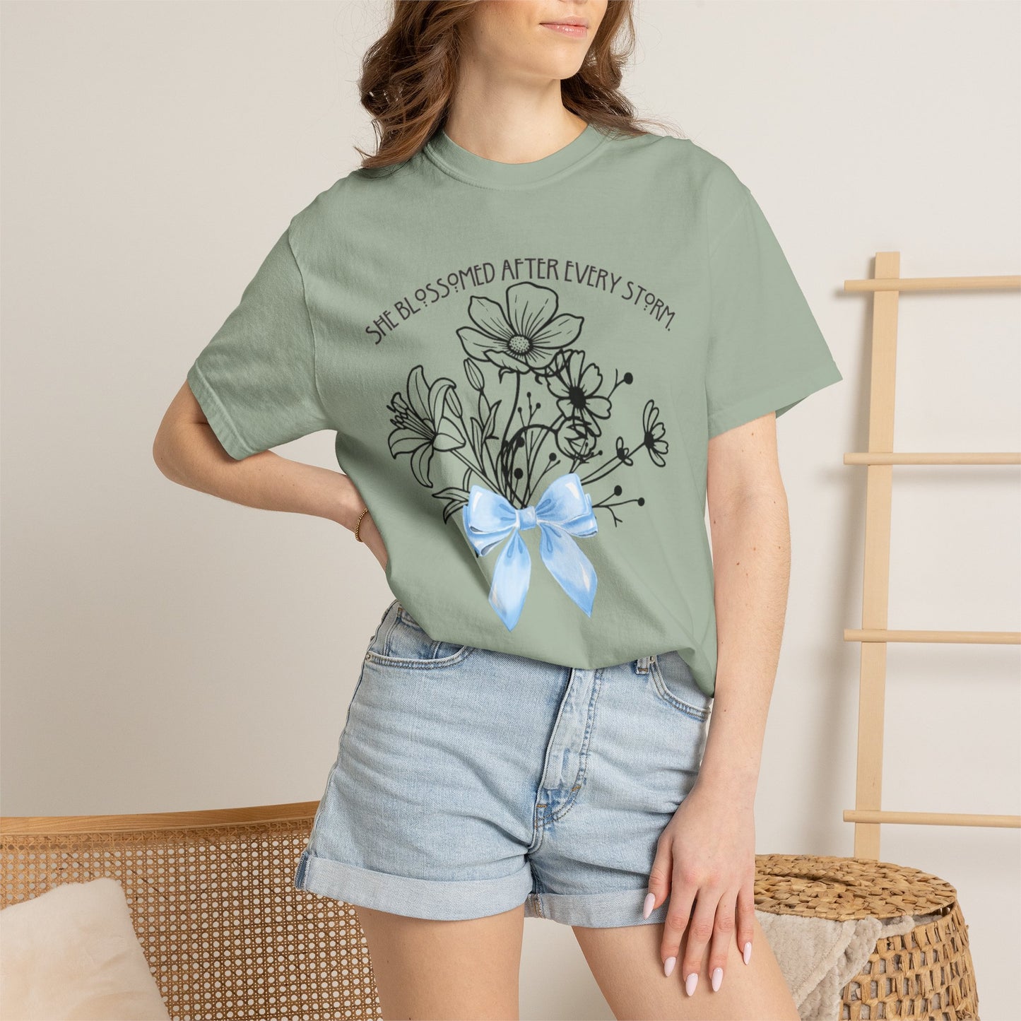 T-Shirt — 'She Blossomed After Every Storm' Floral Bouquet Tee with Blue Ribbon