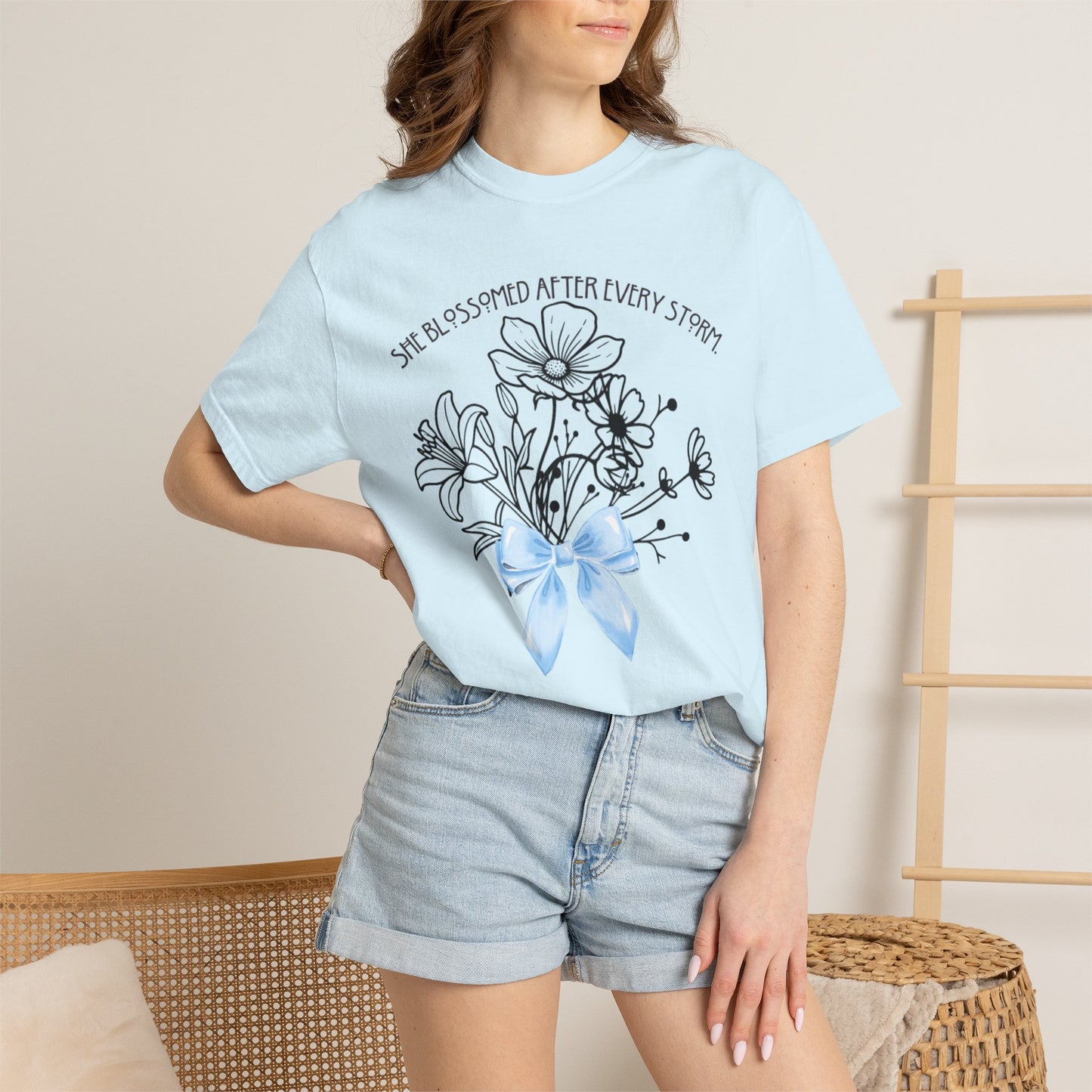 T-Shirt — 'She Blossomed After Every Storm' Floral Bouquet Tee with Blue Ribbon