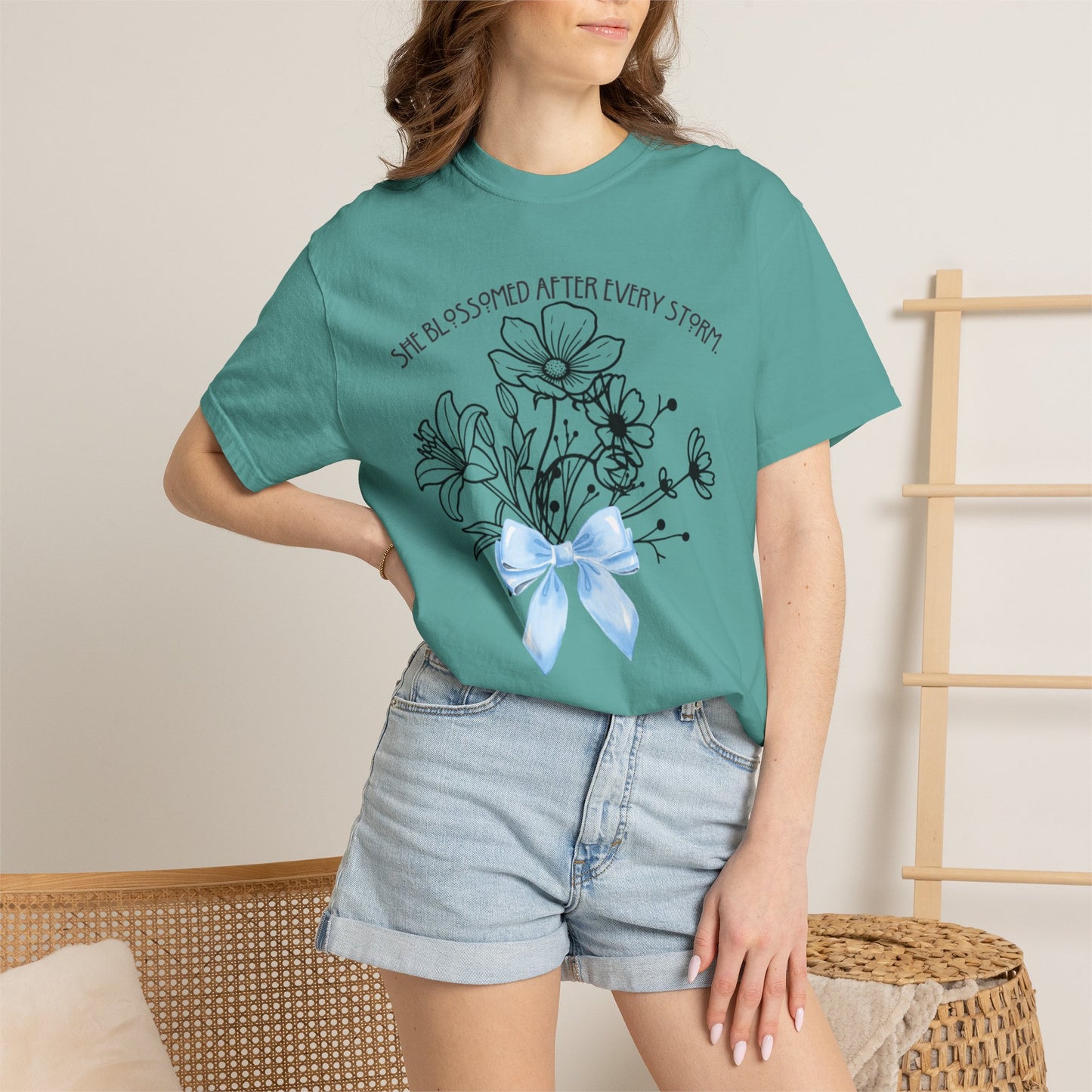 T-Shirt — 'She Blossomed After Every Storm' Floral Bouquet Tee with Blue Ribbon