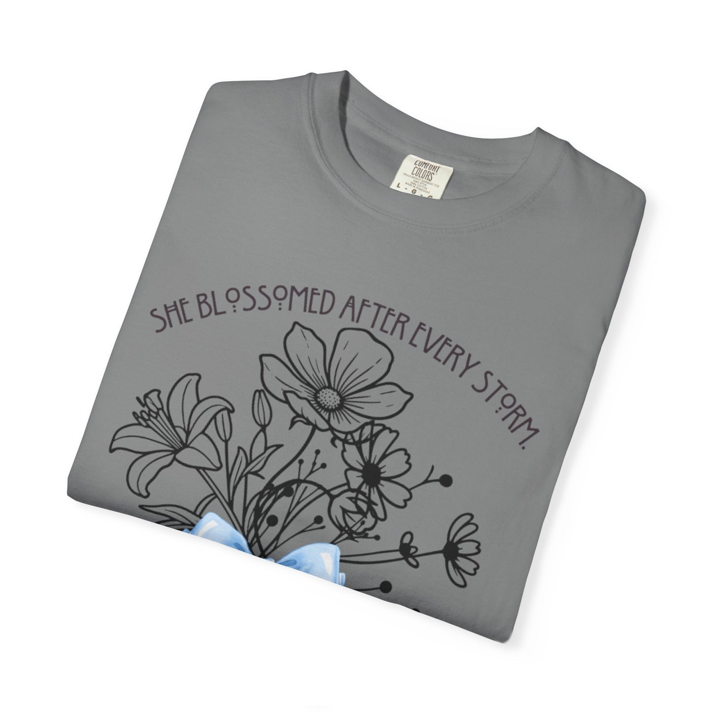 T-Shirt — 'She Blossomed After Every Storm' Floral Bouquet Tee with Blue Ribbon