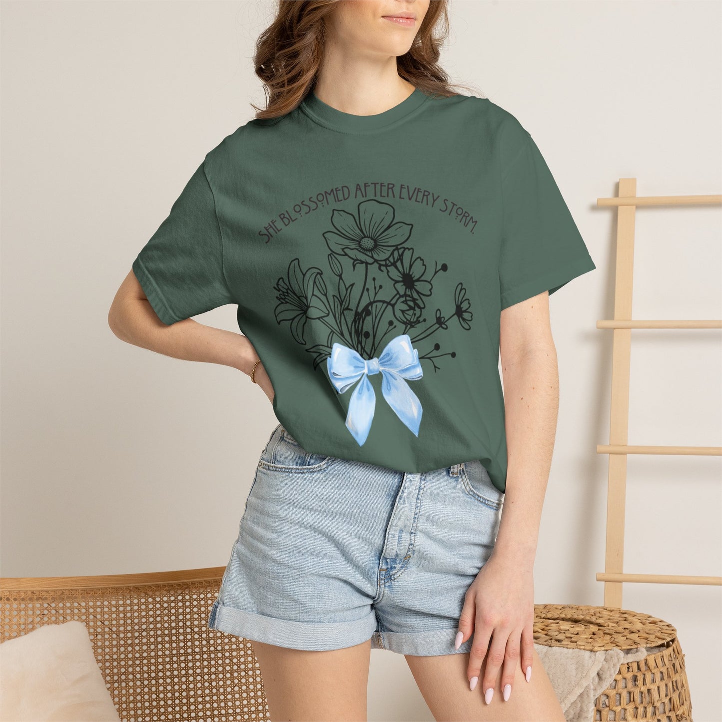 T-Shirt — 'She Blossomed After Every Storm' Floral Bouquet Tee with Blue Ribbon